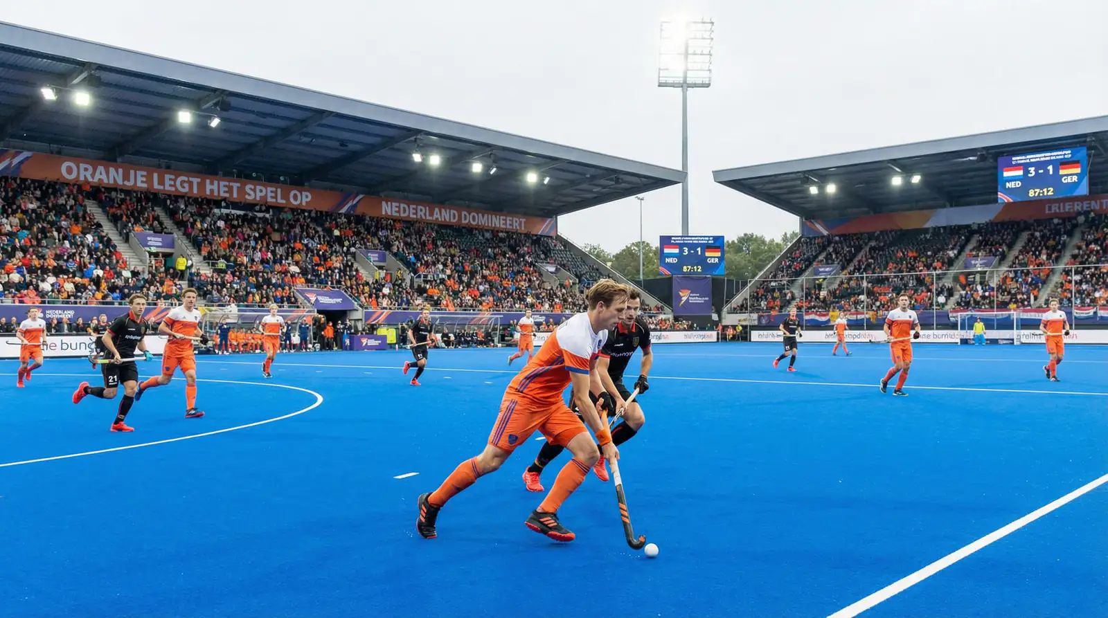 Nederlands veldhockeyteam in oranje shirts